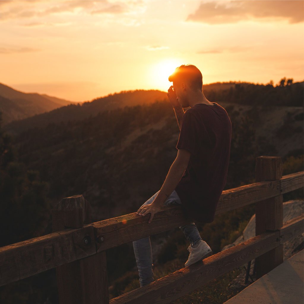Guy sitting on a mountain